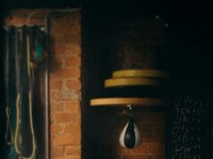 Home Fitness Corner Makeovers: Before and After Dimly lit boxing gym interior with punching bag and workout equipment, evoking a vintage training vibe.