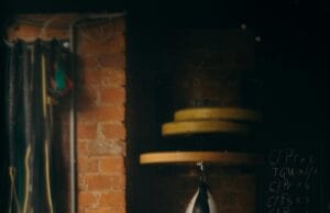 Home Fitness Corner Makeovers: Before and After Dimly lit boxing gym interior with punching bag and workout equipment, evoking a vintage training vibe.