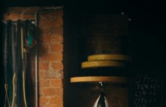 Home Fitness Corner Makeovers: Before and After Dimly lit boxing gym interior with punching bag and workout equipment, evoking a vintage training vibe.